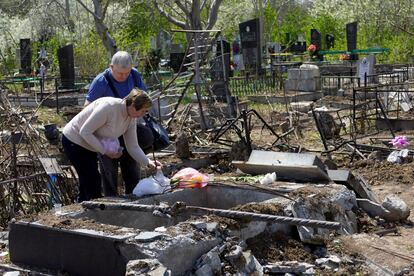 Vecinos de Odesa visitan el cementerio de Tairovske este domingo, dañado por un misil ruso. 