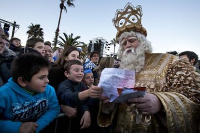 El Rey Melchor lee la carta entregada por un ni&ntilde;o.  