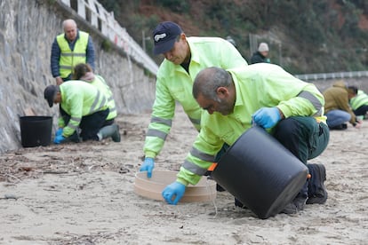 Trabajos de limpieza de pellets este martes en la playa asturiana de Aguilar, en Muros de Nalón. 