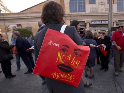 Bag reads "No to the gag law."