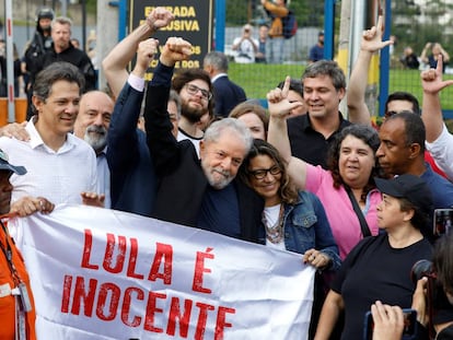 O ex-presidente Lula ao deixar a prisão em Curitiba, abraçado pela namorada e por apoiadores. 