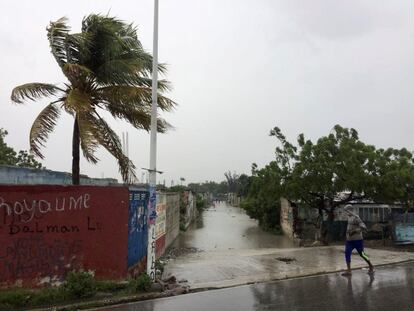 Un hombre camina a través de una calle inundada, en Puerto Príncipe (Haití).