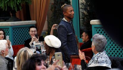 Musician Pharrell Williams presents a creation with a Paris Cosmopolite theme by designer Karl Lagerfeld during the Metiers D&#8217;Art Show for Chanel fashion house in Paris