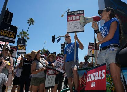 File - Actor and filmmaker Justine Bateman, right, speaks outside Netflix during a Writers Guild rally on July 13, 2023, in Los Angeles.