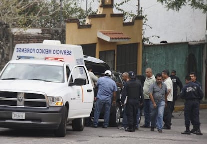 Técnicos forenses y policías extraen el cuerpo del periodista René Orta Salgado del maletero de su vehículo, en Cuernavaca (México).