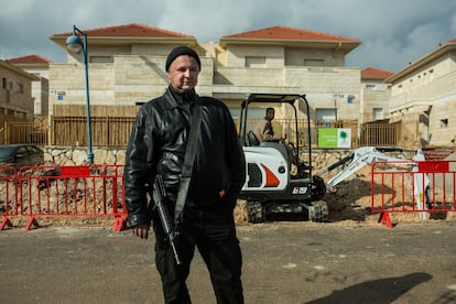 El vigilante armado Alex Izka ante una obra con trabajadores palestinos. “La gente se pone nerviosa si oye hablar árabe cerca de su casa”m dice este judío emigrado desde Crimea hace 17 años.