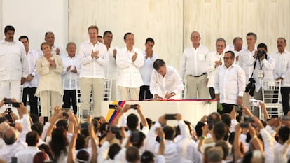 Juan Manuel Santos firma el acuerdo de paz junto a Timochenko, m&aacute;ximo l&iacute;der de las FARC.
 