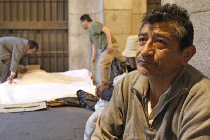 Homeless people preparing to spend a night in the open air in Madrid's Plaza Mayor.