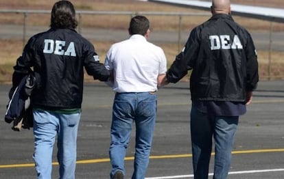 US Drug Enforcement Administration agents lead a suspect away.