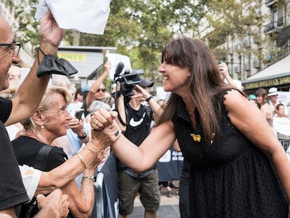 La presidenta del Parlament, Laura Borràs saluda al grupo de la plataforma 'Queremos saber' tras el homenaje a las víctimas en La Rambla.