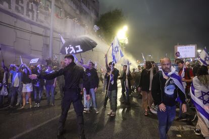 Police use a water cannon against protesters that block the Ayalon main highway during a mass protest against the government's justice system reform plans in Tel Aviv, Israel, 25 March 2023.