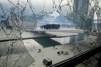 A unit of riot-control officers raise their shields and enter the Brazilian presidential palace.