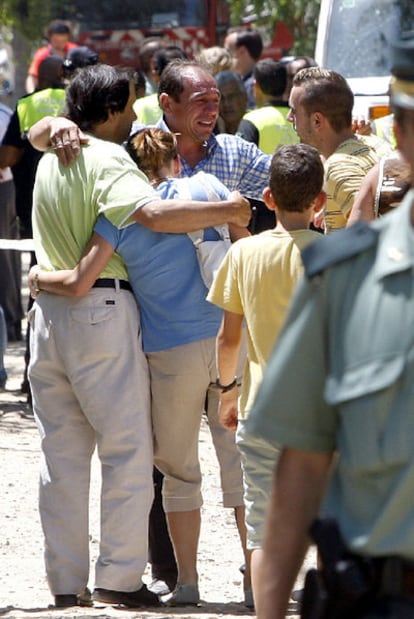 Vecinos de Benacazón se abrazan en el lugar de la tragedia.