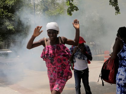 People move away from tear gas fired by officers of the Haitian National Police while clearing a camp of people escaping the threat of armed gangs, in front of the U.S. Embassy, in Port-au-Prince, Haiti July 25, 2023.