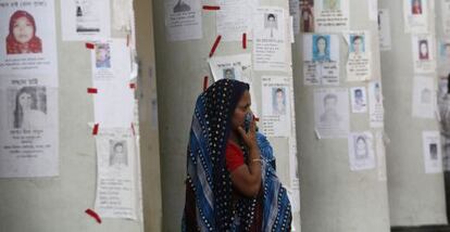 Una mujer rodeada de carteles de desaparecidos en la tragedia del Rana Plaza.