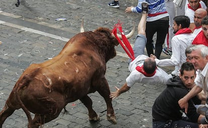 A runner is flipped up into the air during Day 4 of the Running of the Bulls.