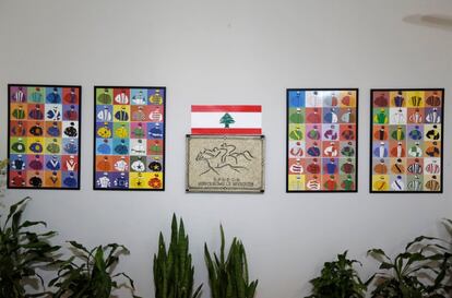 A Lebanese National flag and posters depicting the jockeys' dress codes hang on a wall at Beirut Hippodrome, Lebanon, May 14, 2017. REUTERS/Jamal Saidi  SEARCH "SAIDI HIPPODROME" FOR THIS STORY. SEARCH "WIDER IMAGE" FOR ALL STORIES.