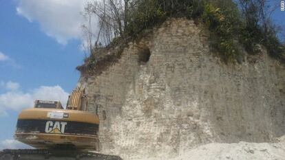 Una excavadora, junto a la pirámide.