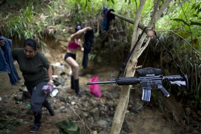El arma de un combatiente cuelga de una rama como un tendedero improvisado, cerca de un campamento rebelde, en el estado de Antioquia, en los Andes del noroeste de Colombia.