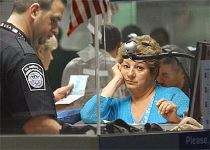 Una mujer espera mientras sus datos son introducidos en el ordenador en enero en el aeropuerto de Miami.