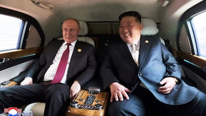 In this photo provided by the North Korean government, North Korean leader Kim Jong Un, right, and Russian President Vladimir Putin talk inside a vehicle as they move in Beijing Wednesday, Sept. 3, 2025. Independent journalists were not given access to cover the event depicted in this image distributed by the North Korean government. The content of this image is as provided and cannot be independently verified. Korean language watermark on image as provided by source reads: "KCNA" which is the abbreviation for Korean Central News Agency. (Korean Central News Agency/Korea News Service via AP)