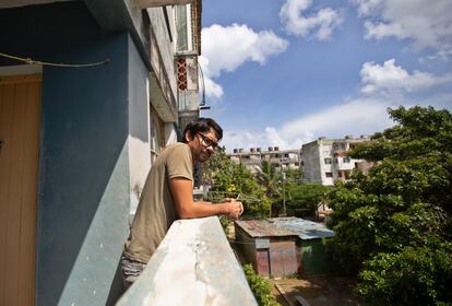 Yunior García, actor y dramaturgo cubano, se asoma a la calle desde el edificio donde vive en la Habana, Cuba, el día 15.