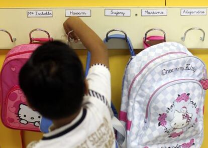 Un alumno coloca su mochila en su colegio. 