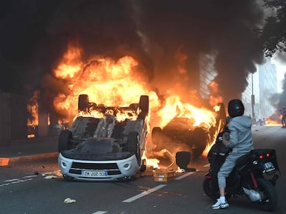 Cars burning in the street at the end of a commemoration march for a teenage driver shot dead by a policeman, in the Parisian suburb of Nanterre, on June 29, 2023.