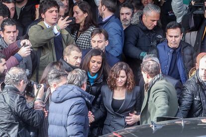 La presidenta de la Comunidad de Madrid, Isabel Díaz Ayuso, rodeada por miembros de su equipo a la salida de un acto en la Complutense en enero de 2023.