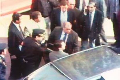 El presidente del PP, José María Aznar, escoltado por dos policías, se dirige al coche que le trasladó desde la Clínica Belén a la Clínica Ruber, tras sufrir un atentado con coche bomba en Madrid. EFE/Archivo