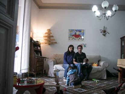 Mery and Gotzon with their two children in their home.