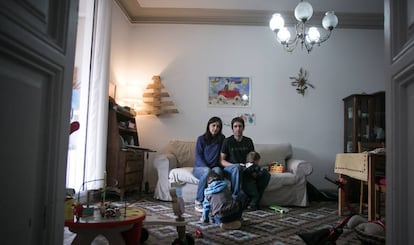 Mery and Gotzon with their two children in their home.