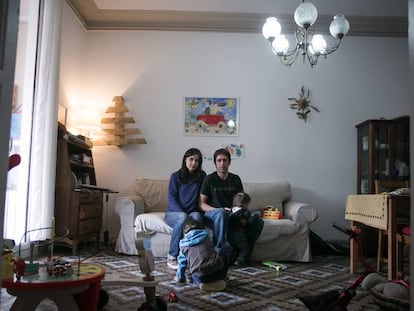 Mery and Gotzon with their two children in their home.