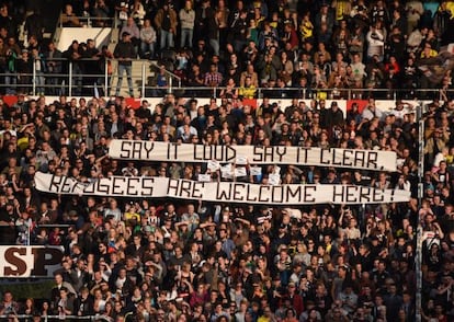 Um cartaz dá as boas-vindas aos refugiados durante um jogo de futebol na Alemanha.