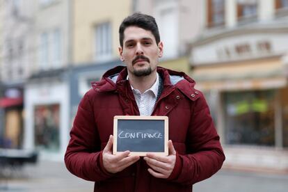 Julien Ambrosio, 27, a salesman, holds a blackboard with the word "confiance" (trust), the most important election issue for him, as he poses for Reuters in Chartres, France February 1, 2017. He said: "We must be able to trust our politicians, but that's more and more difficult with what's going on at the moment." REUTERS/Stephane Mahe SEARCH "ELECTION CHARTRES" FOR THIS STORY. SEARCH "THE WIDER IMAGE" FOR ALL STORIES