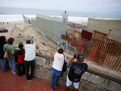People observe a construction crew working in the replacement of the corroded primary border wall between Mexico and U.S., as seen from Playas de Tijuana, Mexico October 16, 2023.