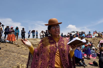 A woman prays at the Incachaca reservoir on the outskirts of La Paz, Bolivia; October 6, 2023.