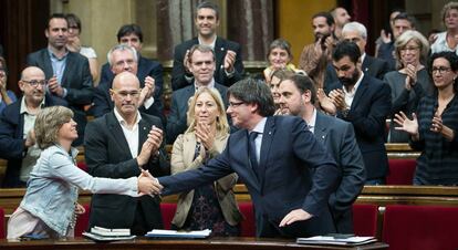 Diputados aplauden al presidente Puigdemont tras superar en votaci&oacute;n la cuesti&oacute;n de confianza.