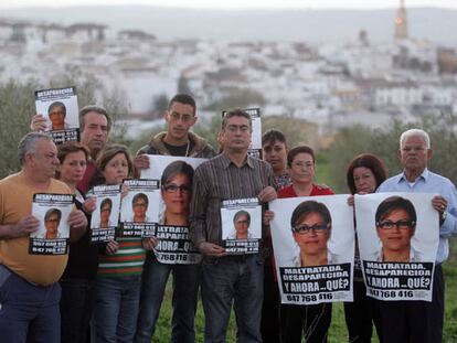 Un grupo de familiares de Ángeles Zurera muestra el pasado viernes carteles con la imagen de la desaparecida, con su pueblo, Aguilar, al fondo.