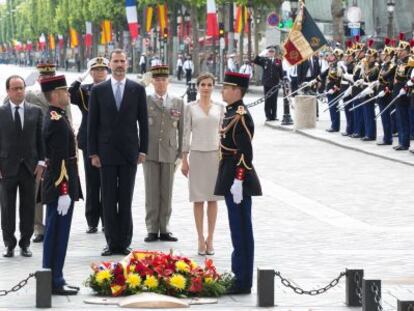 Hollande (izq) acompaña a los Reyes en la ofrenda floral, en París.