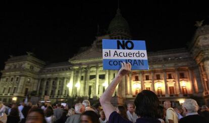 A man holds up a sign during a demonstration to protest against the agreement between Argentina and Iran.