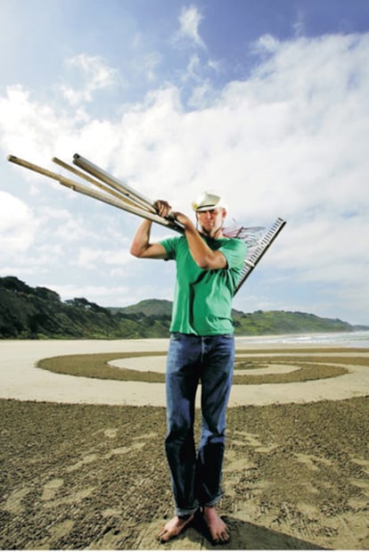 El artista californiano Jim Denevan posa ante una de sus composiciones.