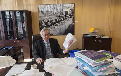 Jean-Claude Juncker holds up a copy of EL PAÍS inside his Brussels office.