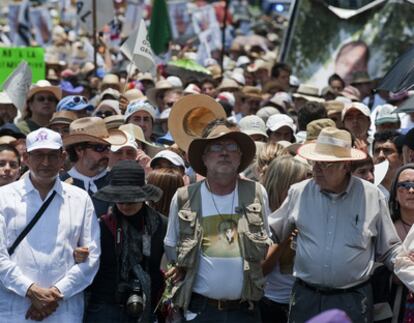 The poet Javier Sicilia, whose son was killed by suspected traffickers, heads up a demonstration in Mexico City.