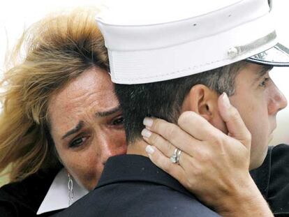 Una mujer llora abrazada a un bombero en Nueva York, durante la ceremonia por el sexto aniversario del 11-S.