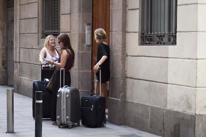 Un grup de turistes esperen davant d'un pis de lloguer a Barcelona.