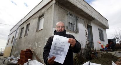 Mohammed Raji posa delante de su casa con la resoluci&oacute;n del TEDH.  