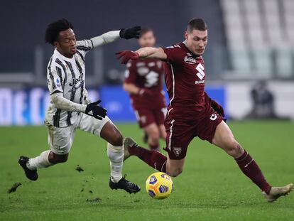 El delantero del Torino Andrea Belotti se lleva el balón ante el juventino Cuadrado.