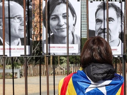 Una simpatizante independentista mira las fotografías de políticos catalanes presos expuestas en la plaza de Schuman (Bruselas).