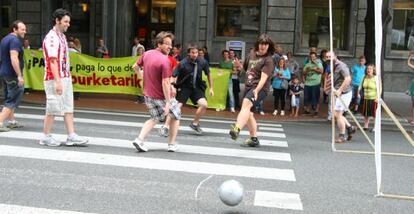 Trabajadores de Panda juegan este martes al fútbol en la Gran Vía de Bilbao.